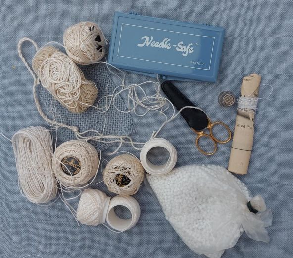 Constance Howard’s working materials and stitching equipment, including DMC threads, beads, and her "Needle-Safe" box, emptied from her bag.