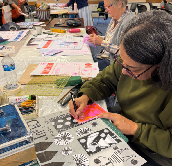 Amarjeet and Alice B concentrating on their zines