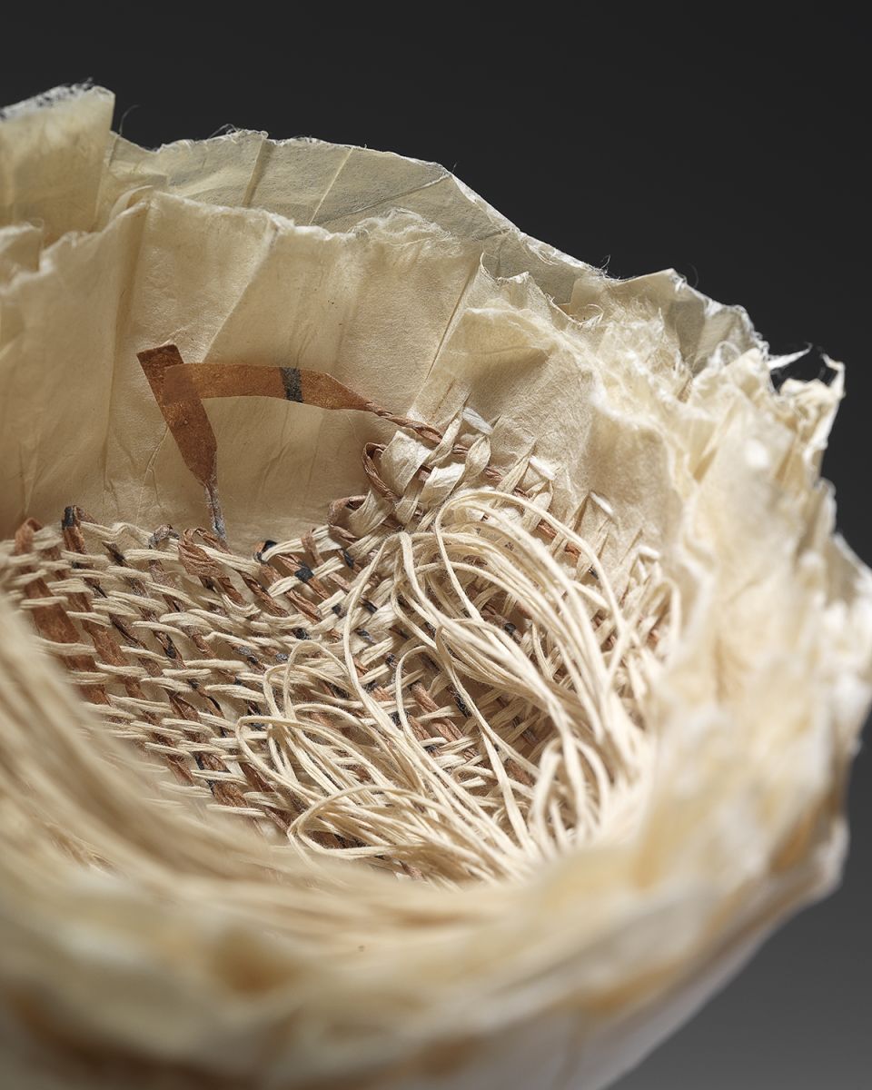 Eleanor Burkett, Mottainai III (detail). Washi paper cast with weaving of persimmon-dyed hand-rolled strips of script and paper warp. Photograph by David Brunetti.